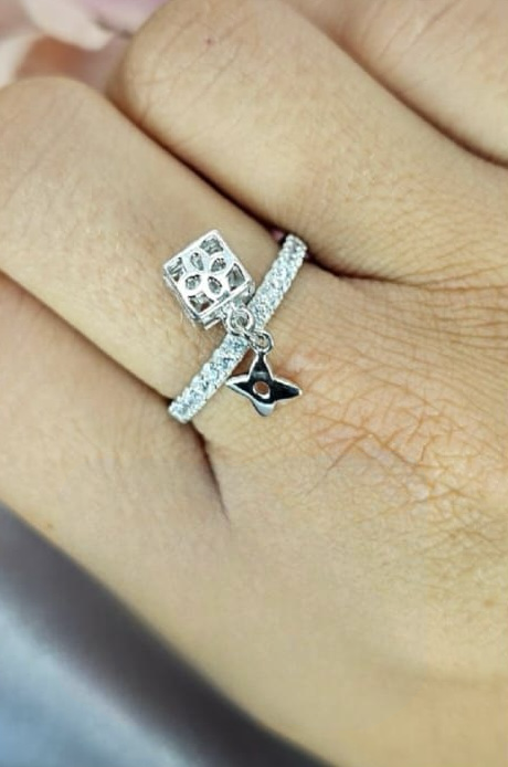 Sterling silver ring with dangling star and flower charms