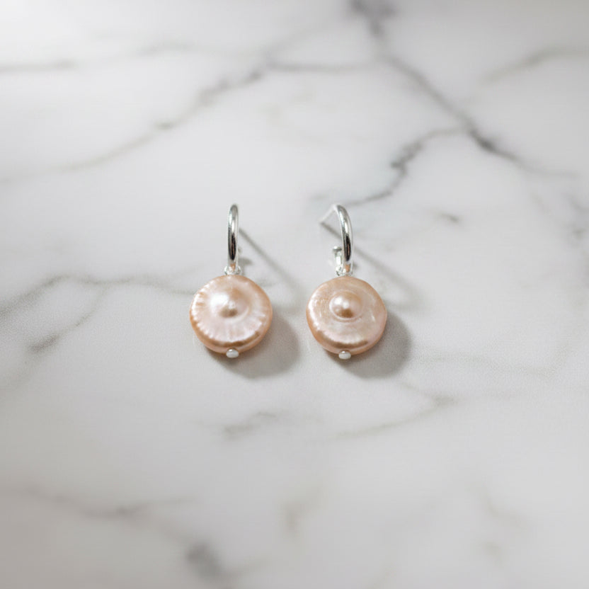Blush coin pearls on a pretty woman hoop