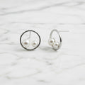 Sterling silver circle stud earrings with two freshwater pearls in circle