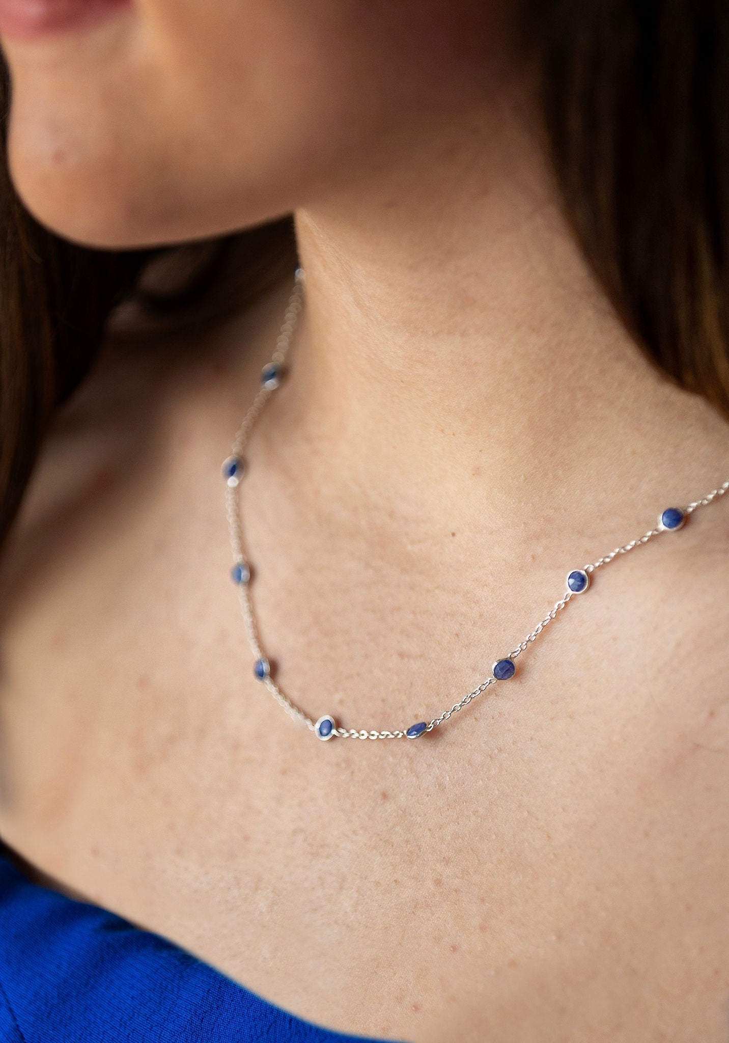 Sterling silver necklace with blue 5mm sapphire semi precious stones in-bedded in necklace