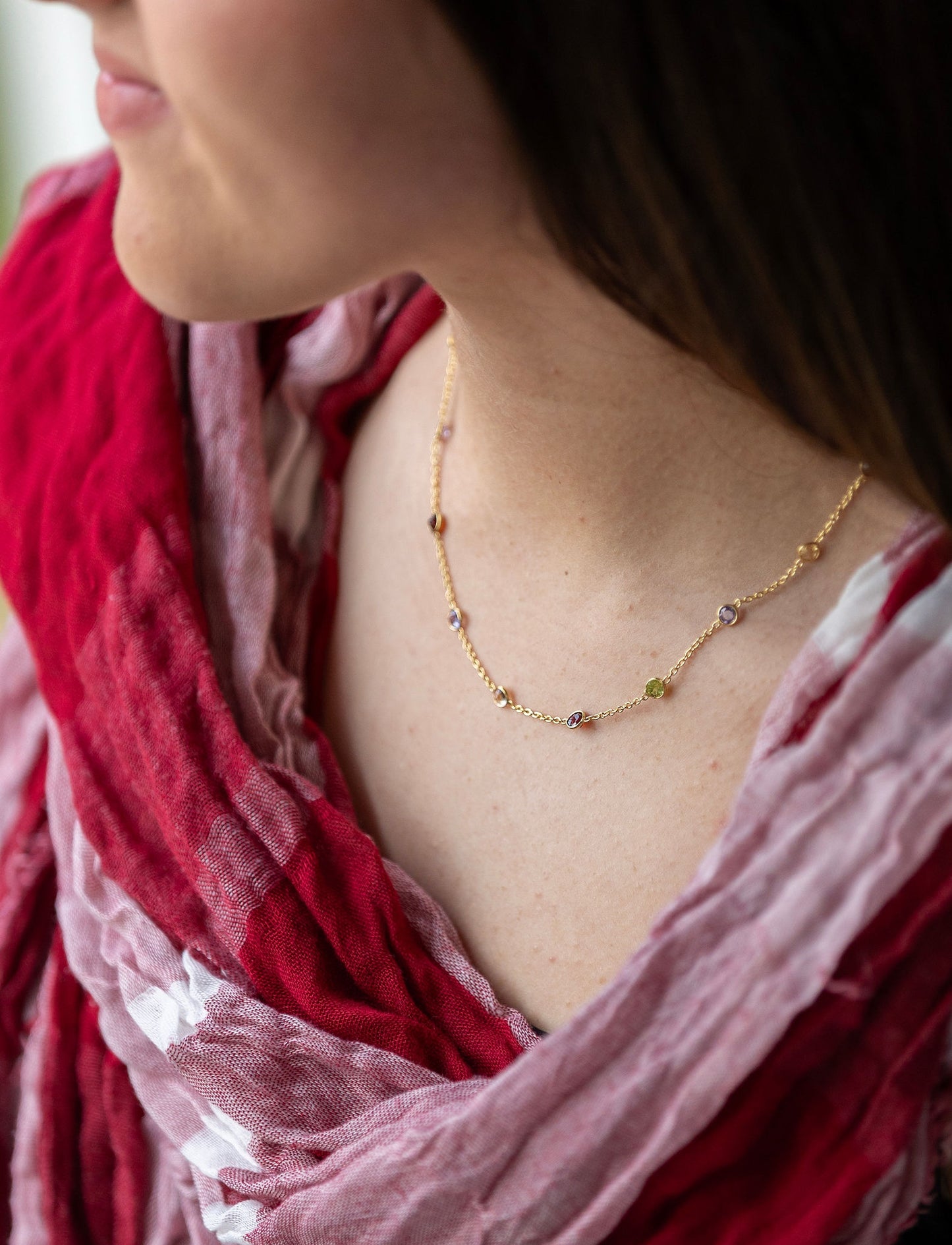 Stunning gold necklace with shades of pink semi precious stones inbedded in chain.