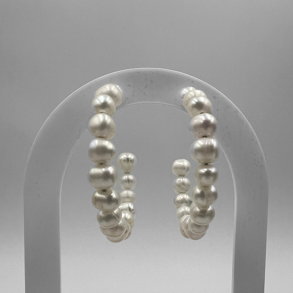 A pair of 40 mm hoop earrings featuring freshwater pearls, displayed against a grey background.