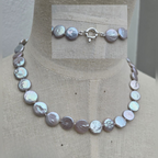 Pearl necklace on a mannequin with a neutral background