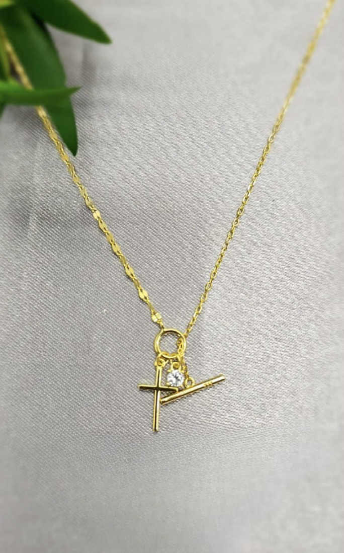 Gold necklace with cross and stone