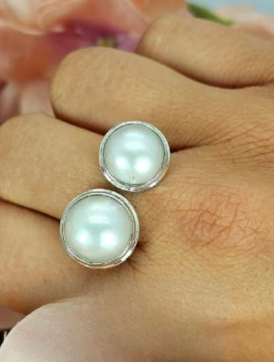 Open size Sterling silver ring with two freshwater pearls nearby