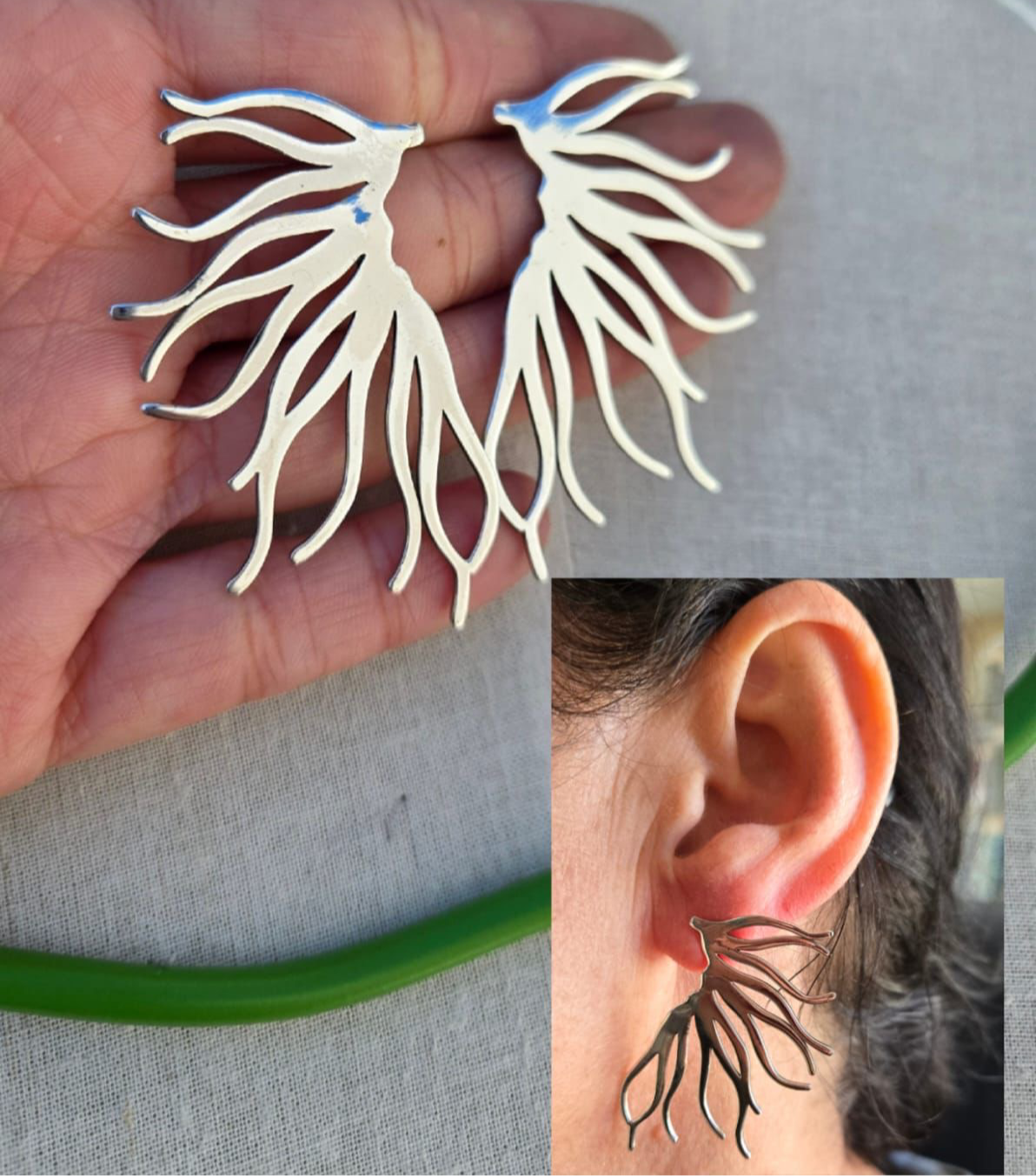 Silver leaf-shaped earrings held in hand with close-up of ear wearing one.