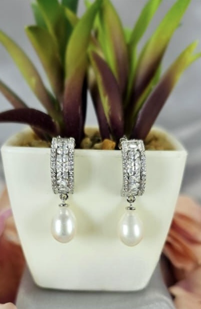 Sterling silver drop earrings with cubic zirconia detail and freshwater pearl on end