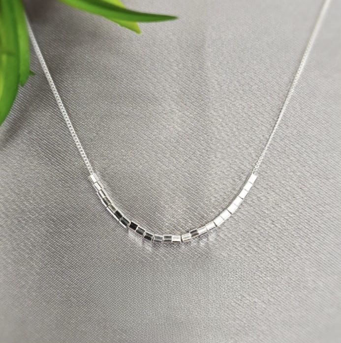 Modern looking necklace with lots of tiny cubics