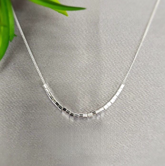 Modern looking necklace with lots of tiny cubics