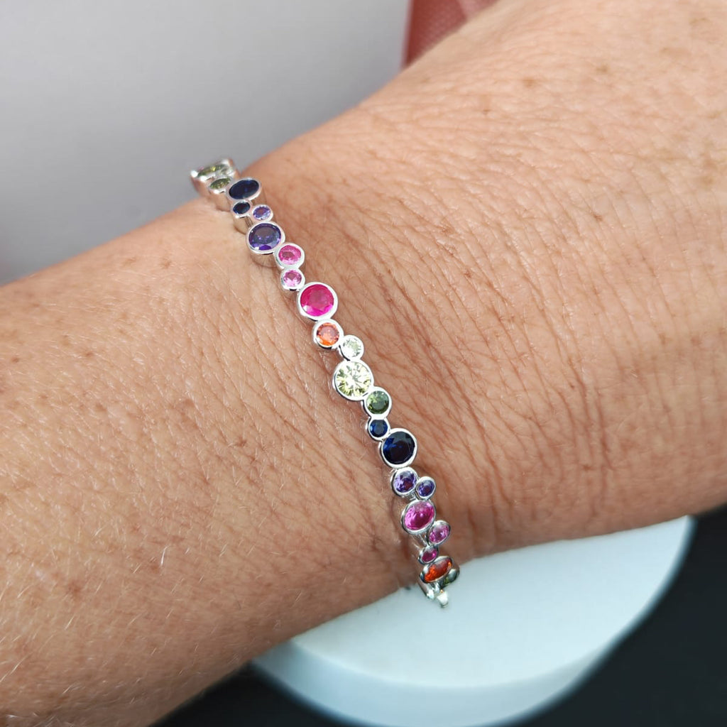 Multicolored beaded bracelet on a wrist with a blurred background