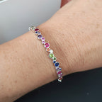 Multicolored beaded bracelet on a wrist with a blurred background