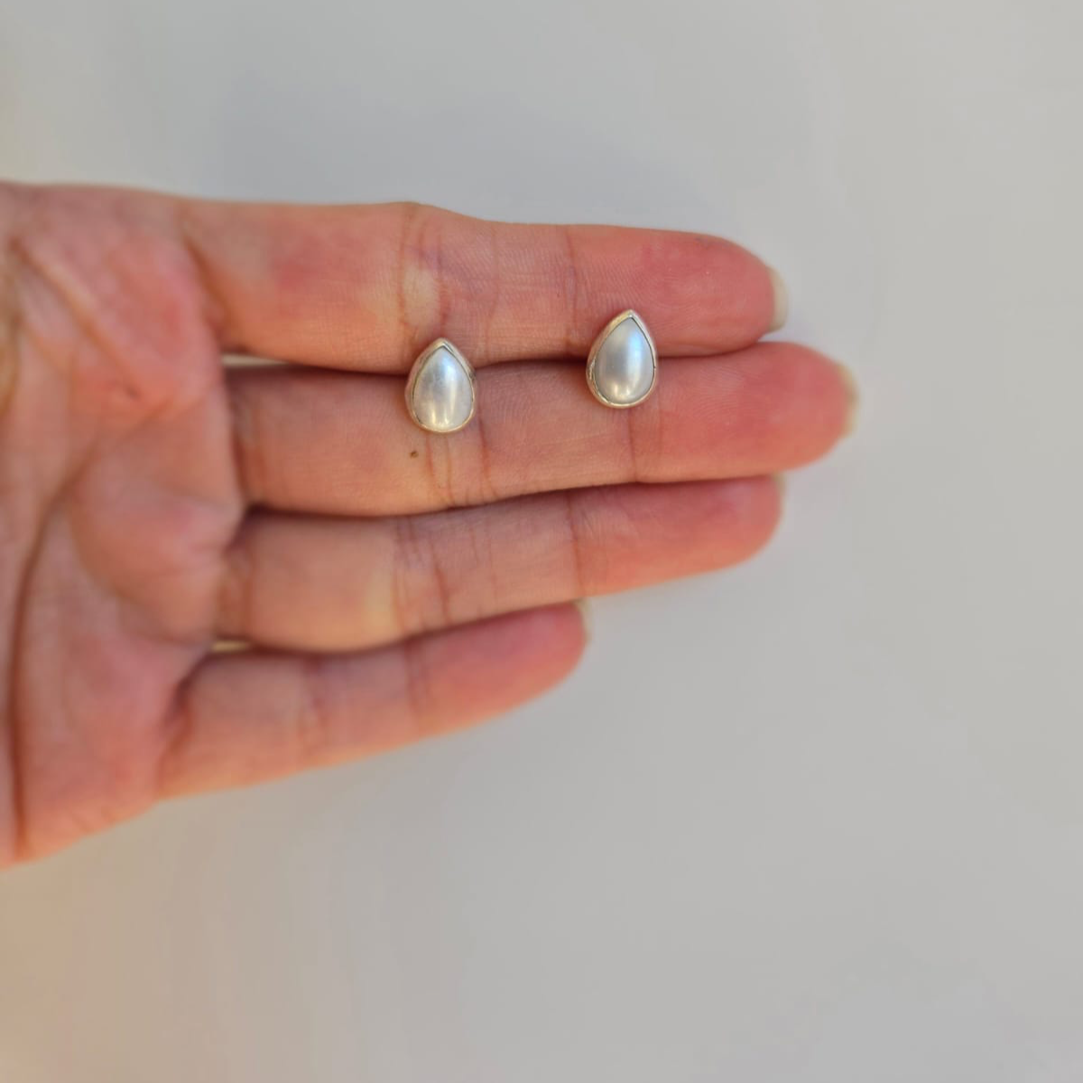 Teardrop pearl stud earrings in tube setting
