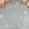 A sterling silver bracelet with heart charms displayed against a floral background.