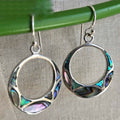Silver hoop earrings with colorful inlay on a neutral background