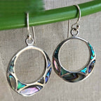 Silver hoop earrings with colorful inlay on a neutral background