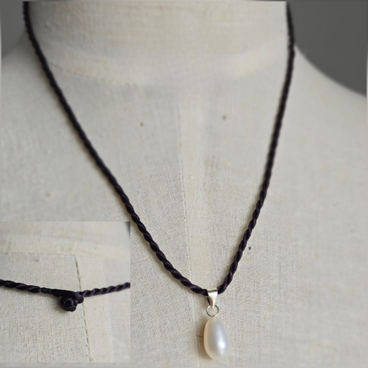 Black silk cord with freshwater pearl pendant on it