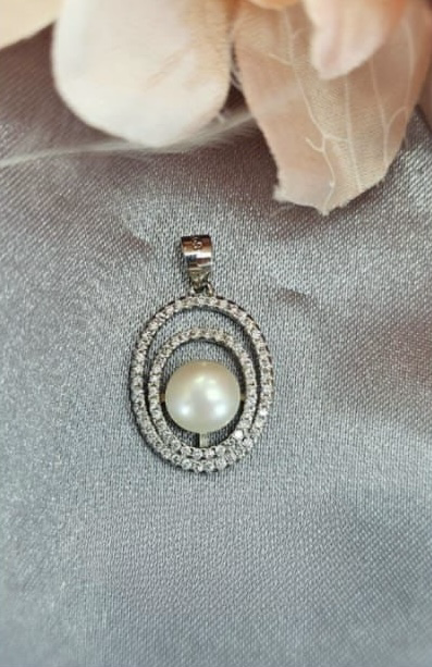 Double circle pendant with cubic zirconia detail and freshwater pearl centre