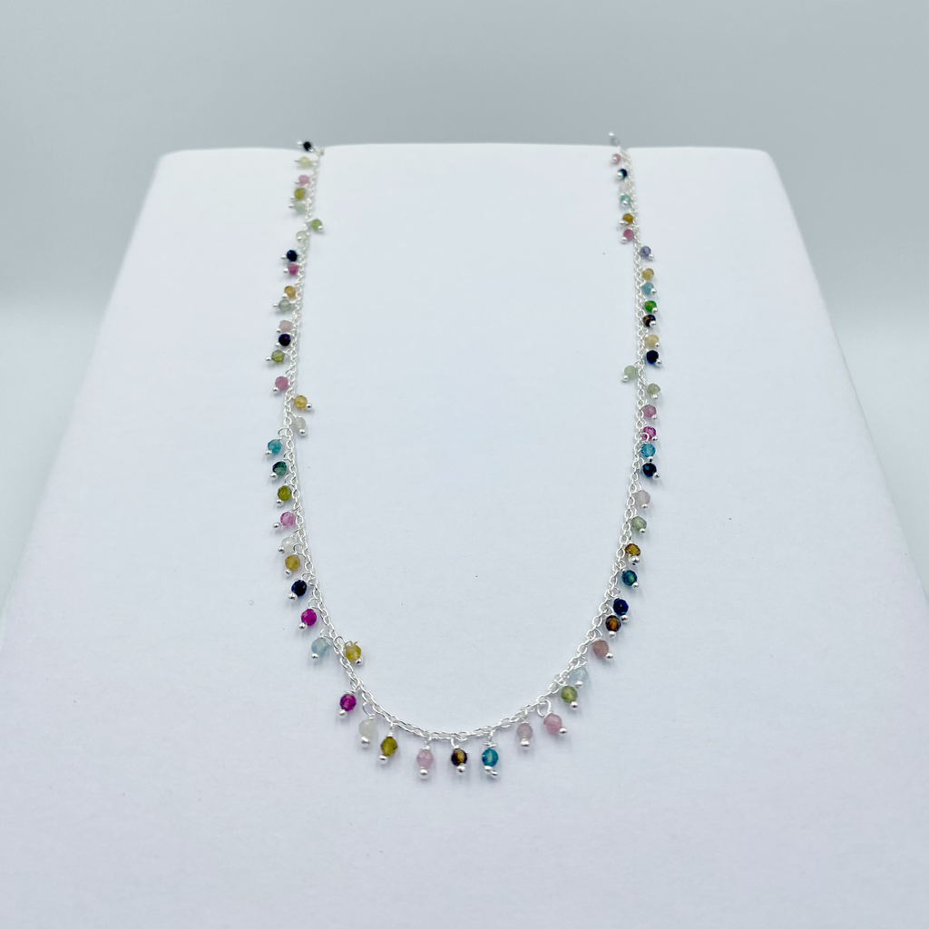 A Tourmaline drops necklace with semi precious stones and sterling silver, displayed on a white background.
