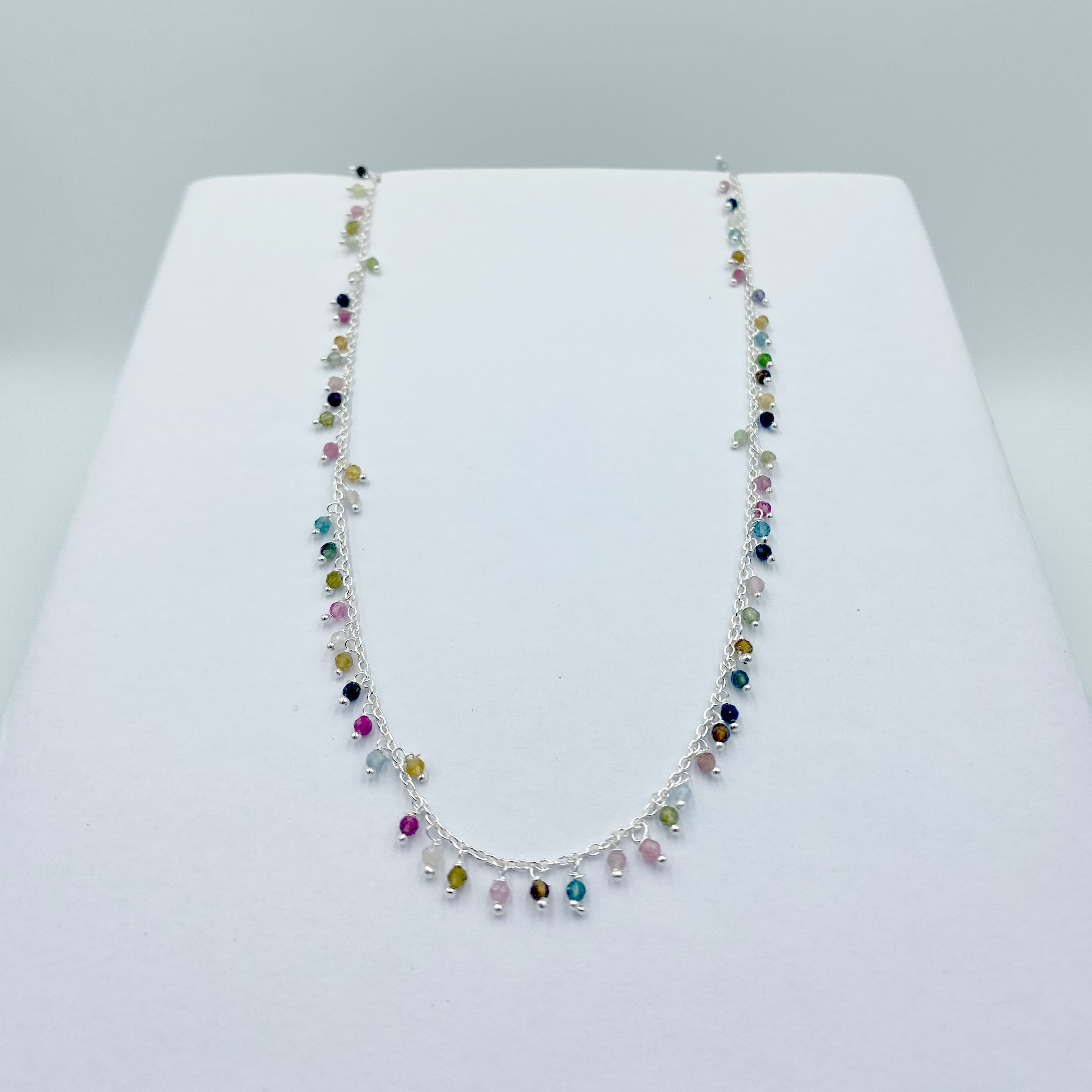 A Tourmaline drops necklace with semi precious stones and sterling silver, displayed on a white background.