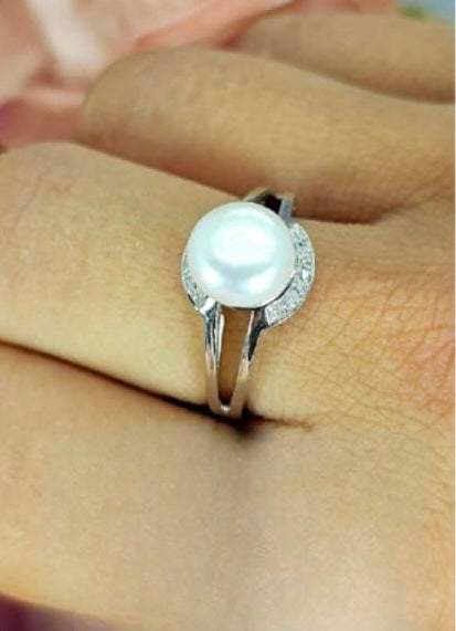 Sterling silver ring with cubic zirconia detail around a stunning freshwater pearl