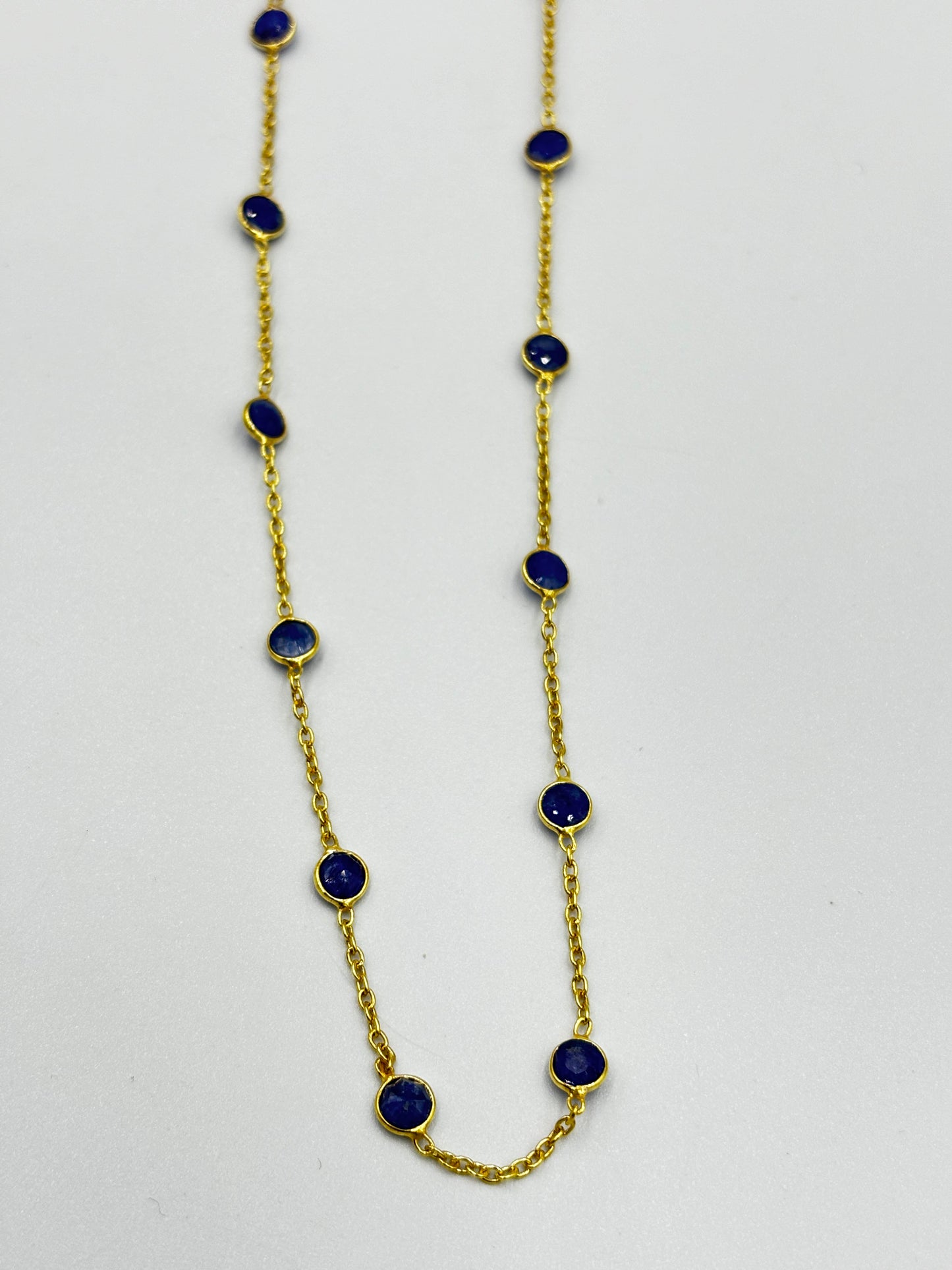 Stunning gold necklace with blue semi precious stones in chain setting