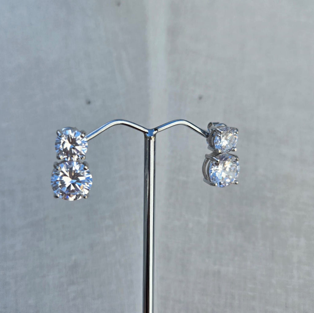 Pair of diamond earrings on a gray background