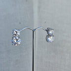 Pair of diamond earrings on a gray background