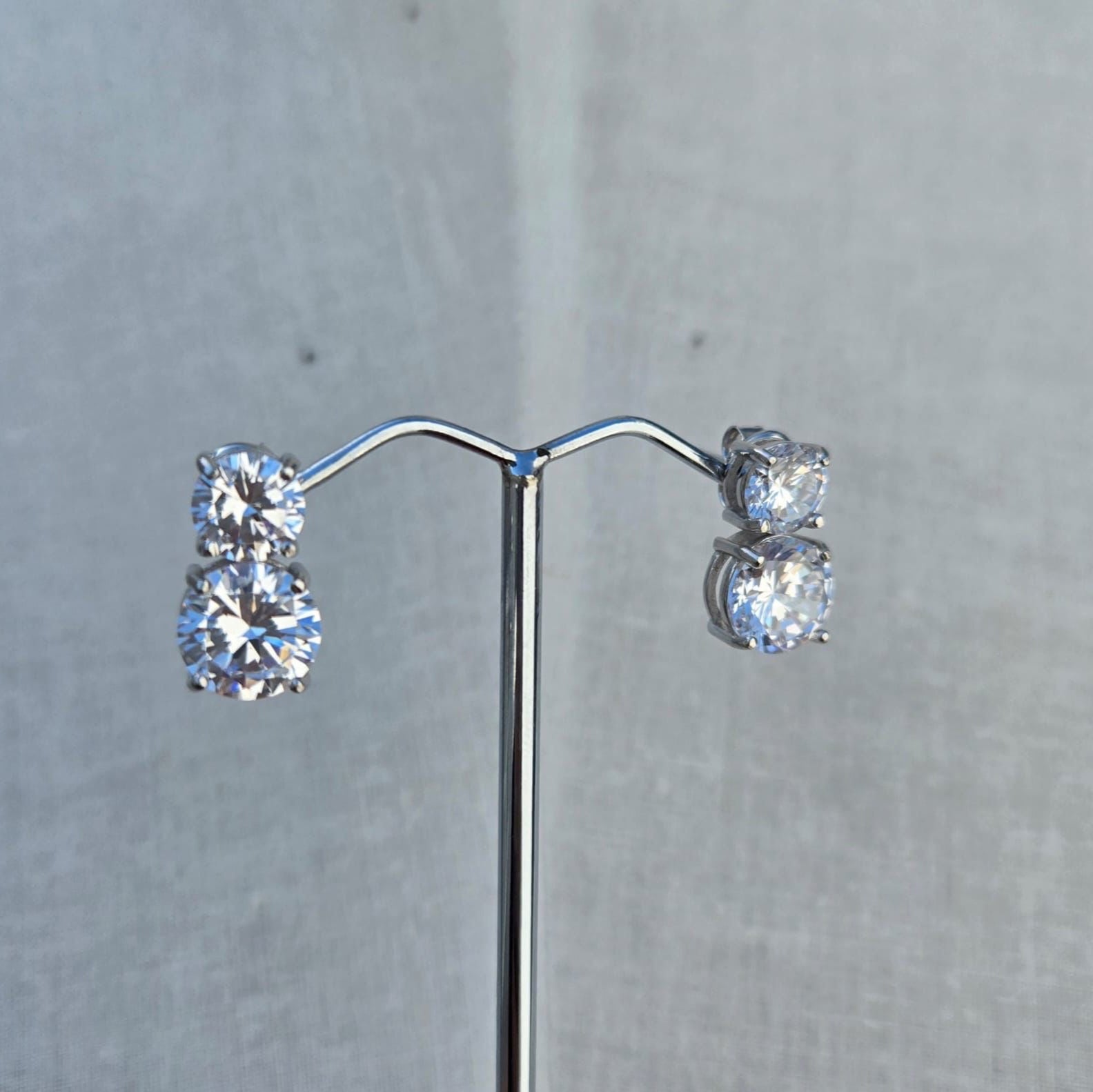 Pair of diamond earrings on a gray background