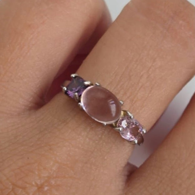Close-up of a ring with pink stone on a finger