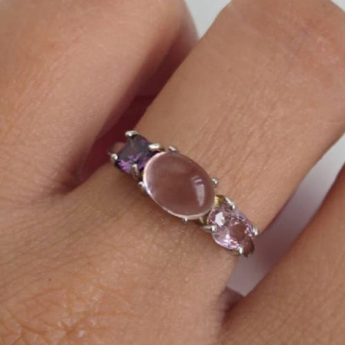 Close-up of a ring with pink stone on a finger