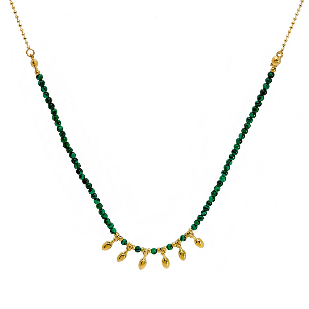 Necklace with green beads and gold pendants on a white background