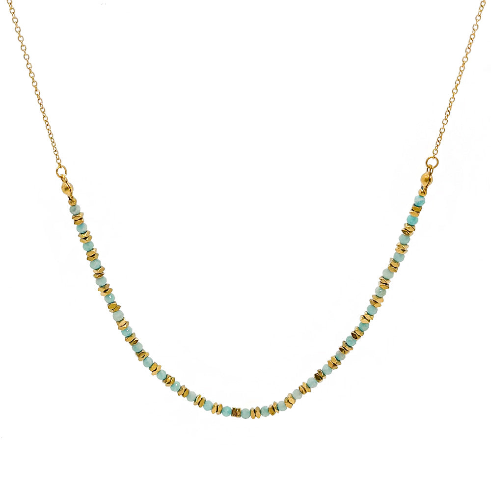 Necklace with gold and turquoise beads on a white background