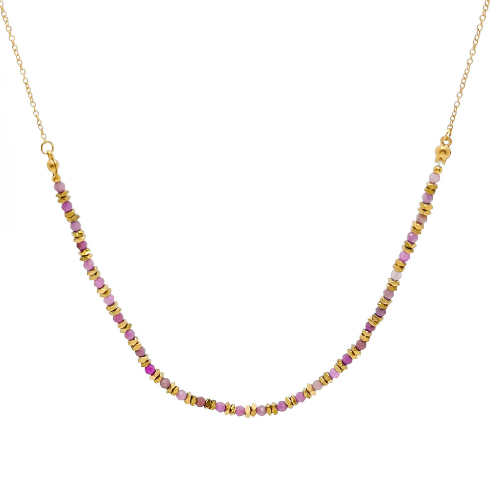Necklace with pink and gold beads on a white background