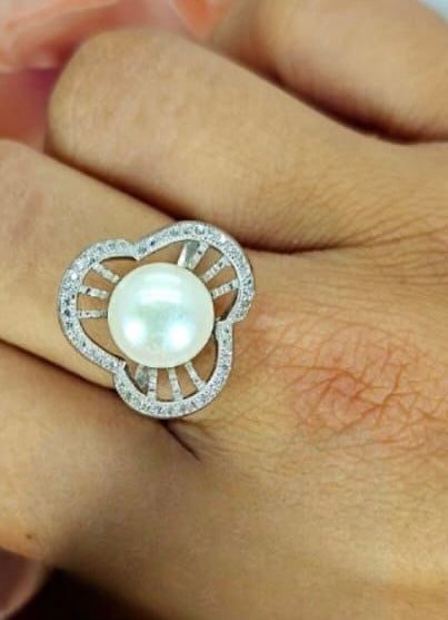 Pavé cubic zirconia flower setting around stunning freshwater pearl ring