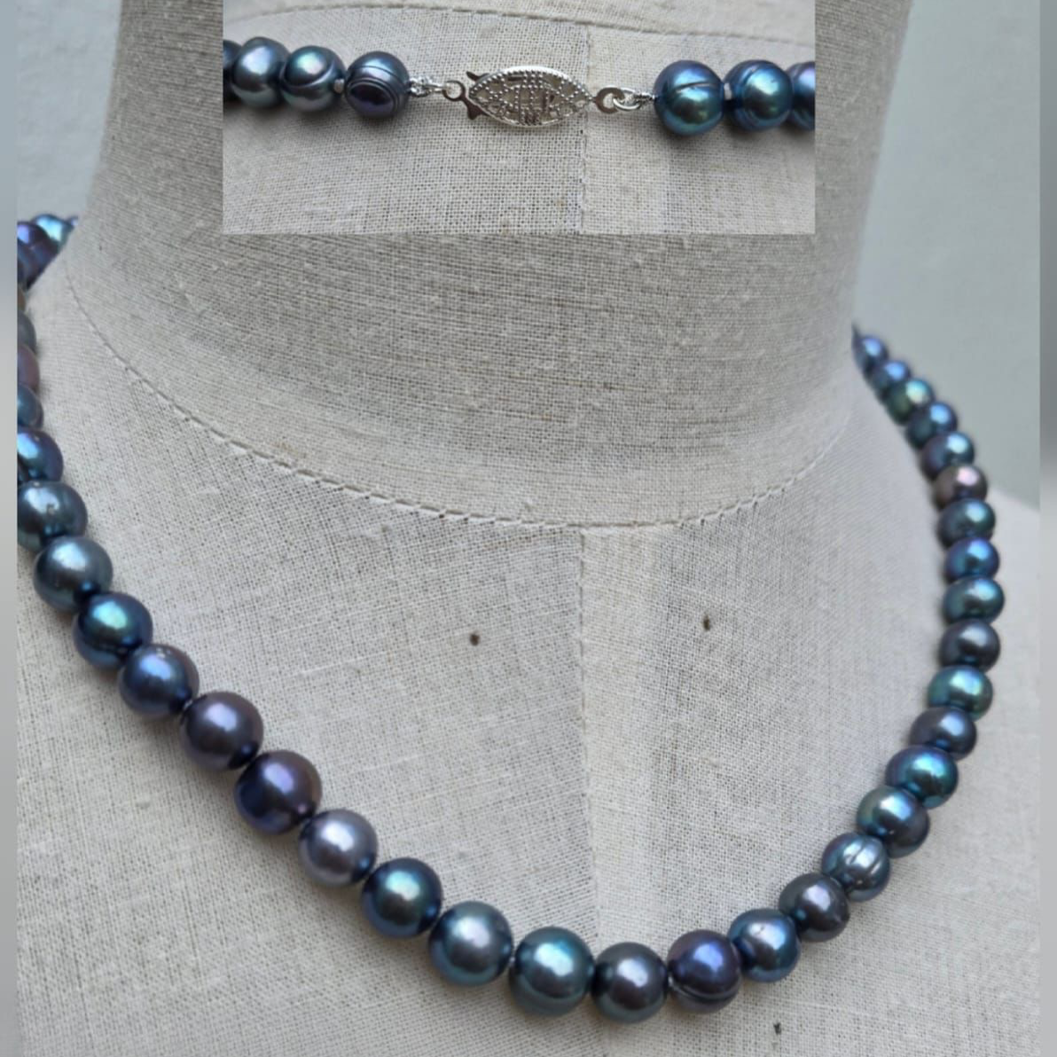 Black pearl necklace on a mannequin with close-up inset