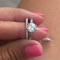 Diamond ring on a finger with pink nail polish