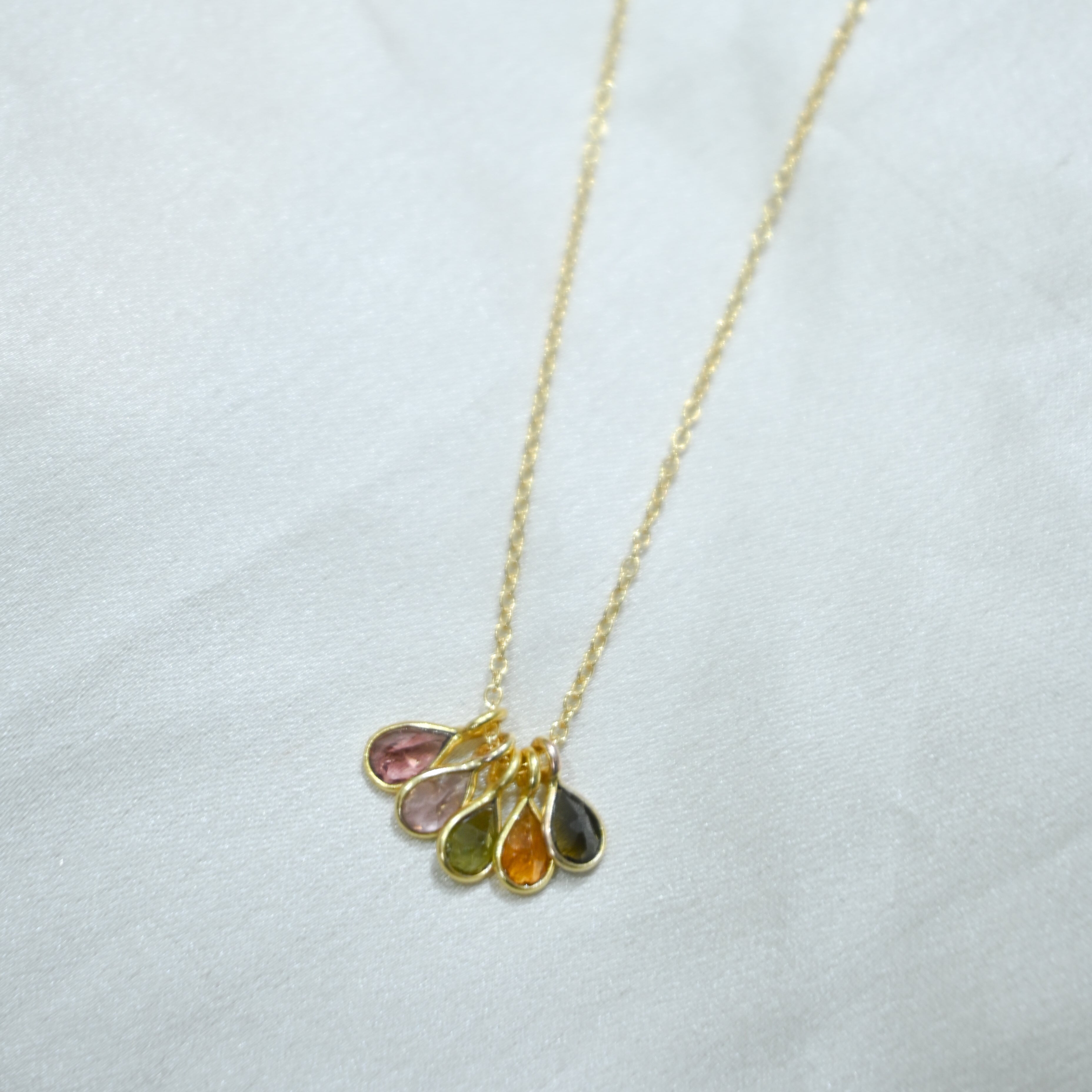 Necklace with multicolored teardrop-shaped pendants on a white background