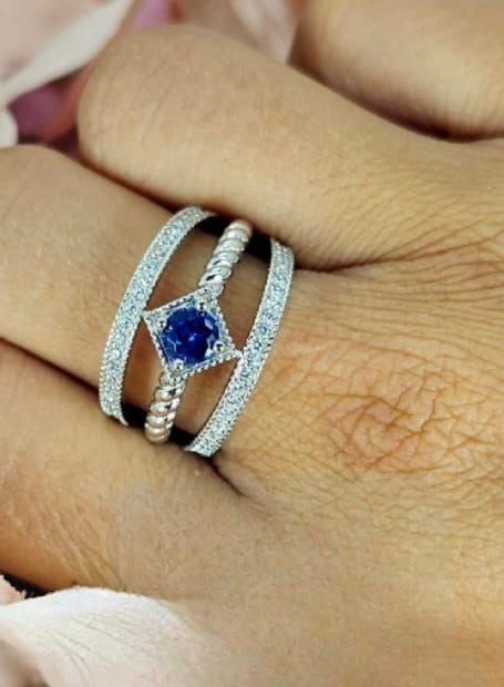 Sterling silver three band ring with diamond shaped blue cubic zirconia