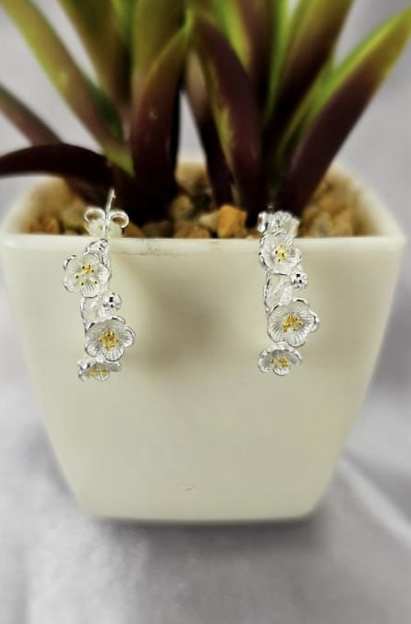 Three daisy half hoop earrings