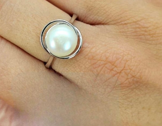 Sterling silver ring with large freshwater pearl and soft wave setting around pearl