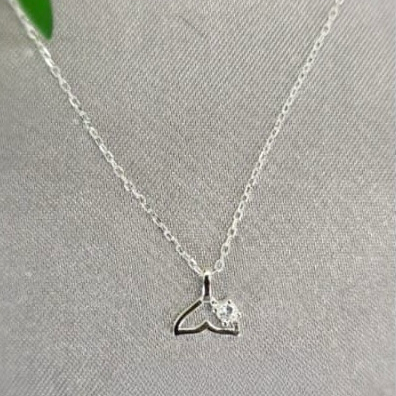 A sterling silver necklace with a cubic zirconia embellished tail, displayed against a light background.