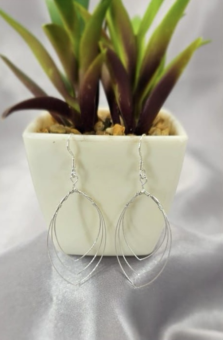 Three delicate oval earrings