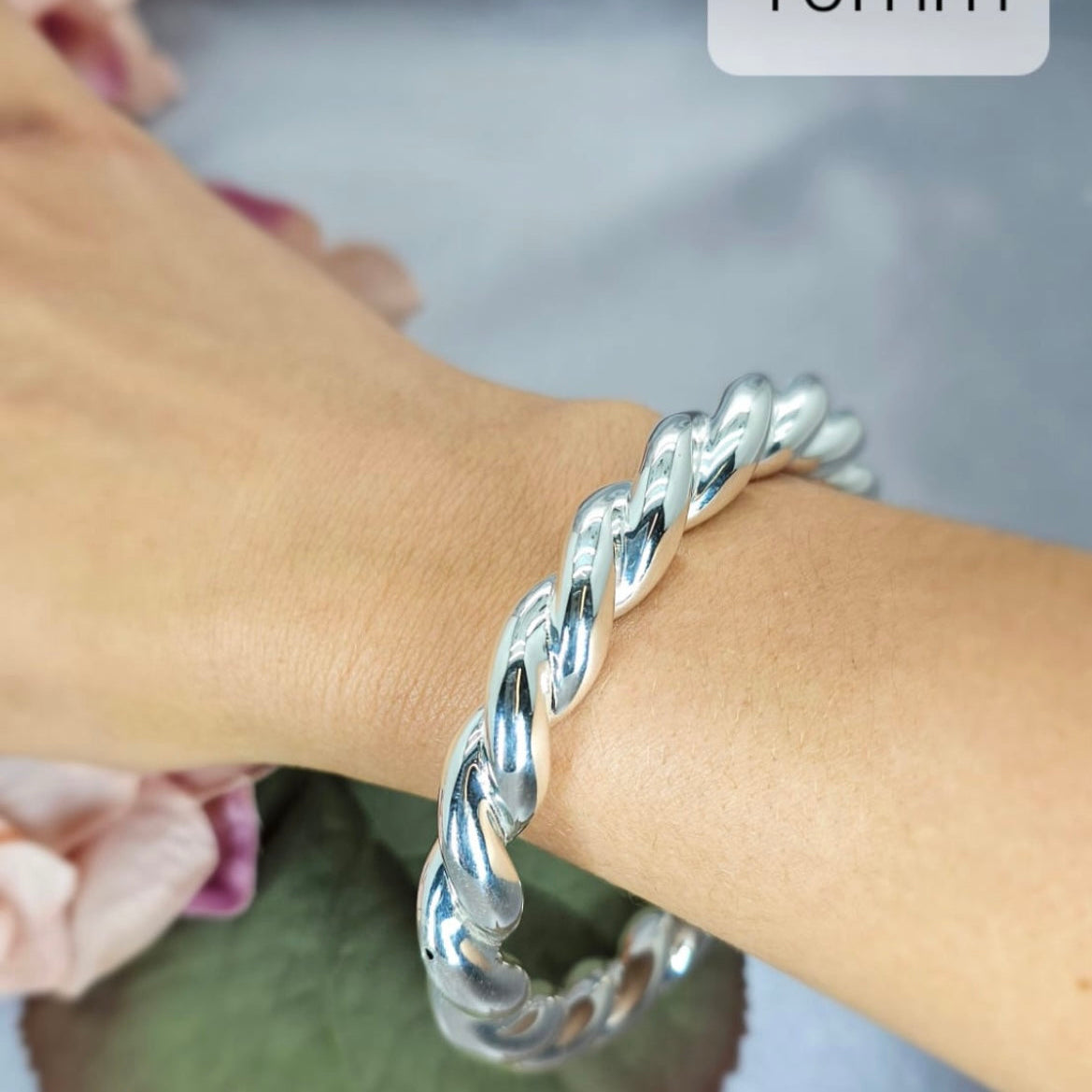 A sterling silver chunky hollow rope bracelet on a person's wrist, with a label showing the rope width as 10mm.
