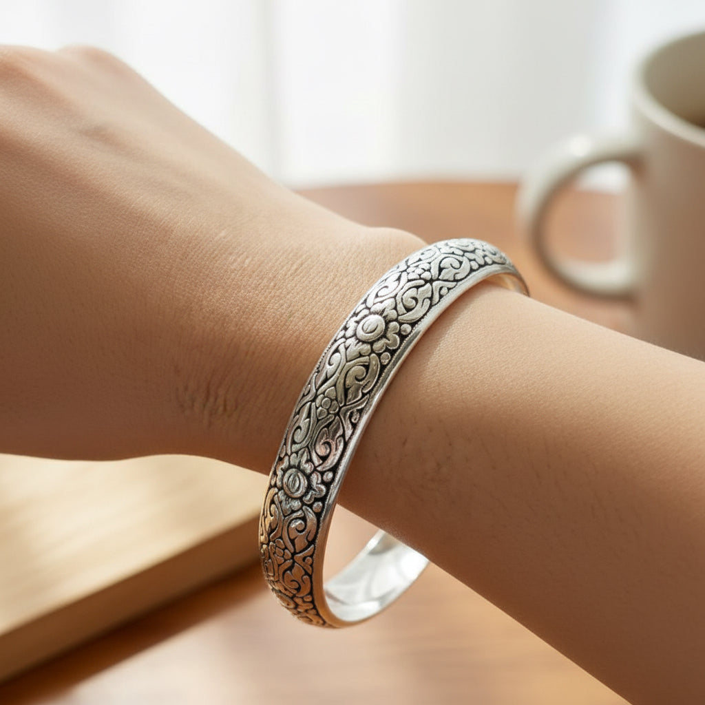 A sterling silver bracelet with a bold pattern worn on a person's wrist, with a label showing the width of 13mm.