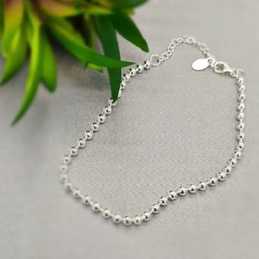 A sterling silver bracelet featuring a series of 3mm balls, with an adjustable clasp, displayed on a neutral background.