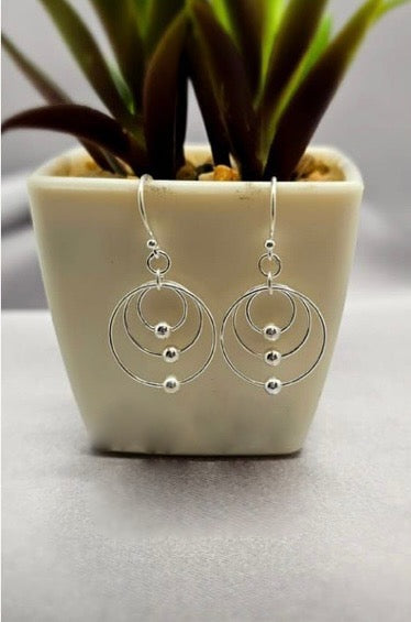 Three circles with ball earrings