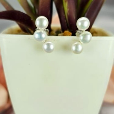 Three pearl ear shaped stud earrings
