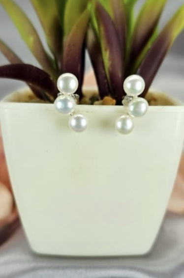 Three pearl ear shaped stud earrings