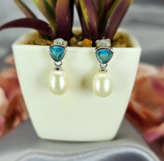 Stunning Sterling silver drop earrings with lovely freshwater pearls and stunning Blue Topaz semi precious stone on top