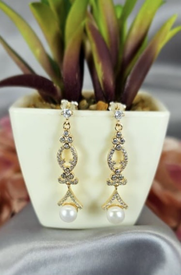 Rose gold long drop earrings with freshwater pearls on end